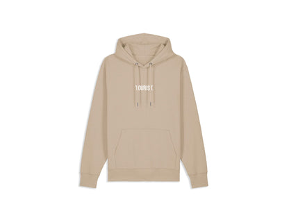 Zandkleurige hoodie TOURIST. op de voorkant.