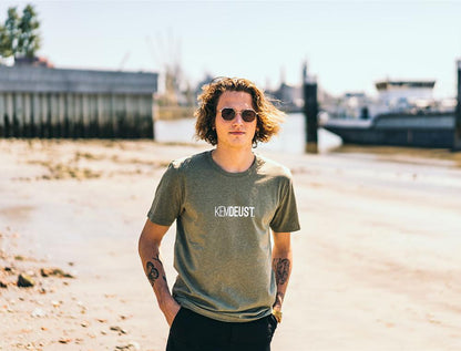 Man met kaki T-shirt met opdruk KEMDEUST.