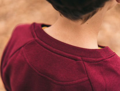 Close-up van een bordeaux trui.