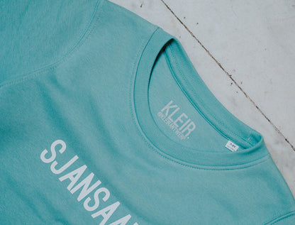 Close-up van een blauw-groene trui.