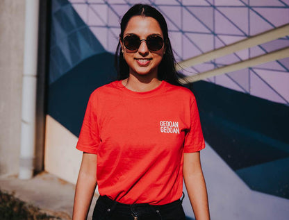 Vrouw met rode T-shirt met opdruk GEDOANGEDOAN.